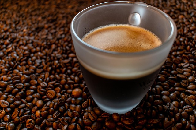 Three different bags of organic coffee blends arranged on a marble countertop with a glass carafe of brewed coffee and linen napkin in soft natural light