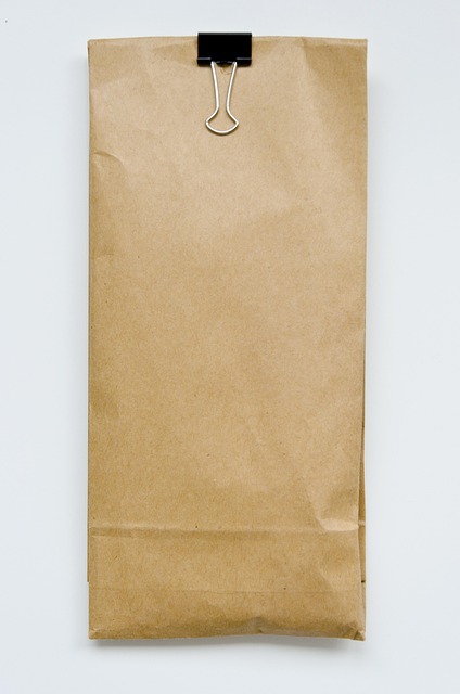 House Blend organic coffee beans in a kraft paper bag with olive and terra branding on a clean wooden kitchen table