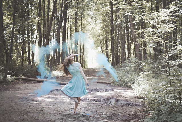 Handcrafted ceramic pour-over coffee dripper in a warm terracotta glaze on a wooden tray with a kettle and steaming coffee in the background